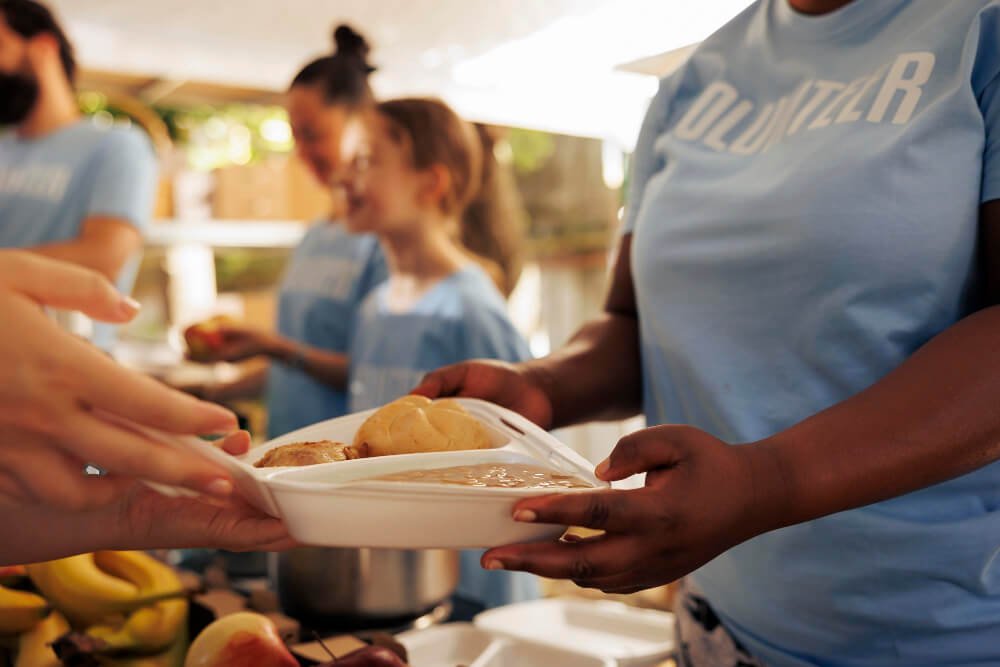 Close-up of a young black woman hands distributing fresh produce
